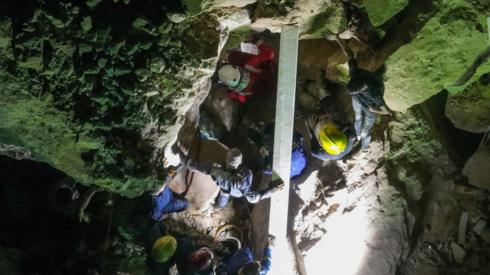 An aerial picture shows members of Iraqi emergency services scanning the rubble for victims following a landslide at the Qattarat al-Imam Ali shrine on the outskirts of the holy city of Karbala, late on August 20, 2022.