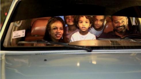 A family watch a movie screening at the Sudanese European Film Festival.