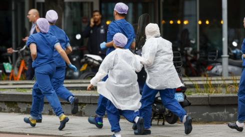 Medical staff leave the Erasmus MC Rotterdam hospital on Rochussenstraat, which has been cordoned off after two shooting incidents in Rotterdam, Netherlands, 28 September 2023.