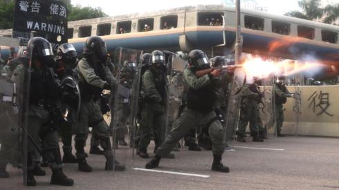 Riot police fire the tear gas while protesters take part in an anti-government march in Kwun Tong, Hong Kong, China, 24 August 2019.