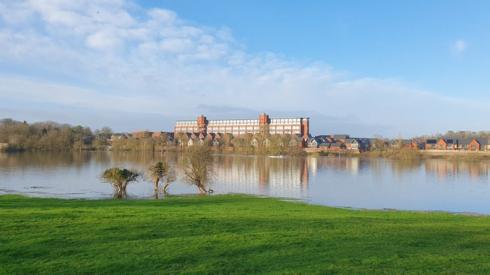 A factory reflected in water