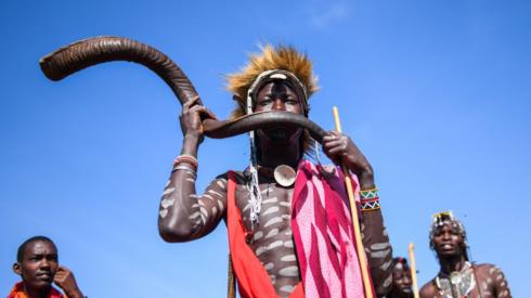 Masaai man playing traditional instrument, 8 August 2023