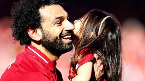Mohamed Salah hugs his daughter Makka as wife watches