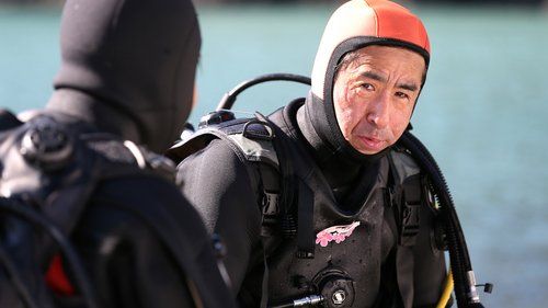 Yasuo Takamatsu listens to his diving instructor