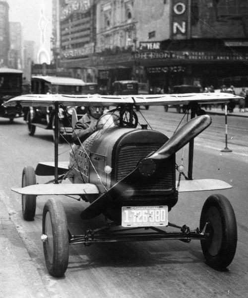 1924 flying car driving through Times Square, New York