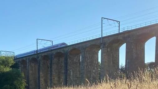 A transpennine train crossing the viaduct just outside Alnmouth station 