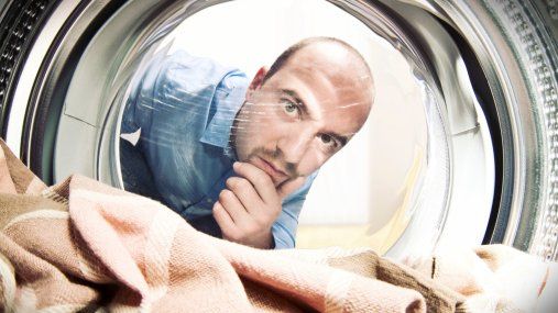 man looking into washing machine