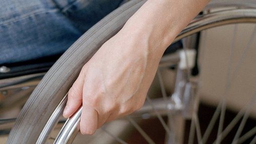 Hand on wheelchair