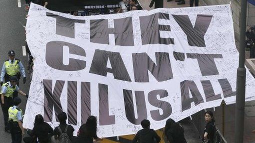Demonstrators carry a banner that reads "They can't kill us all" during a march against violence on journalists in Hong Kong, 2 March 2014
