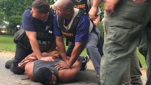 Suspect Willie Cory Godbolt held to the ground by police