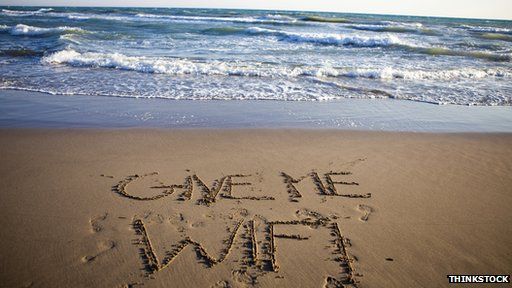 "give me wifi" written on beach