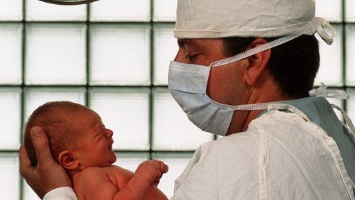Man holding his new-born baby