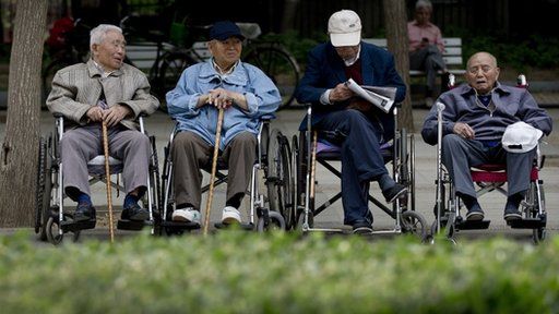 File photo: a group of elderly men take a rest on their wheelchairs at a park in Beijing on 23 May 2013