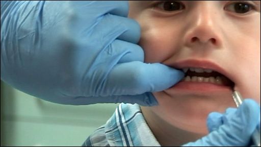 Child having teeth inspected