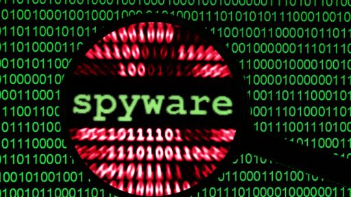 Spyware written in an eyeglass surrounded by code
