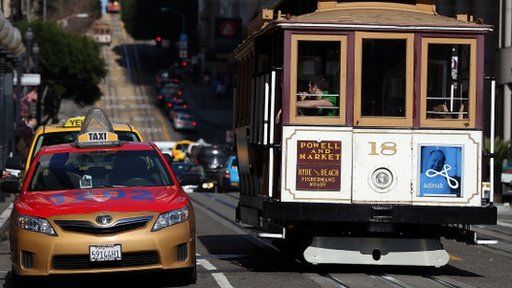 A cab and cable car in San Francisco