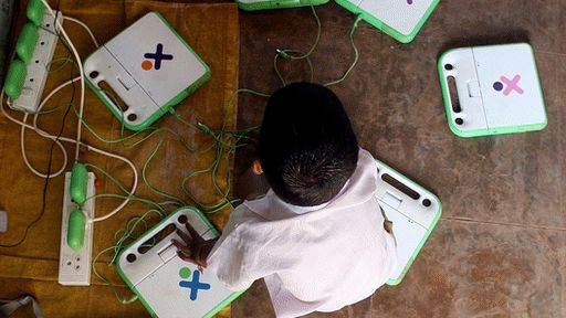 Child with a series of OLPC machines
