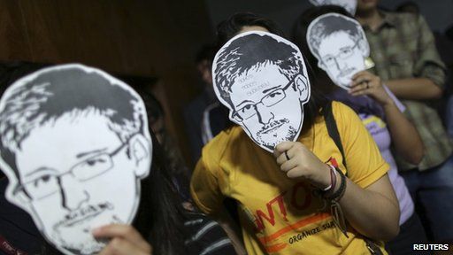 People wearing Edward Snowden masks