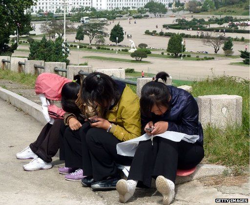 Women using mobile phones in Pyongyang