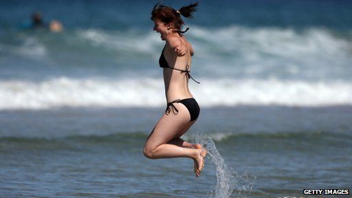 woman jumping in sea