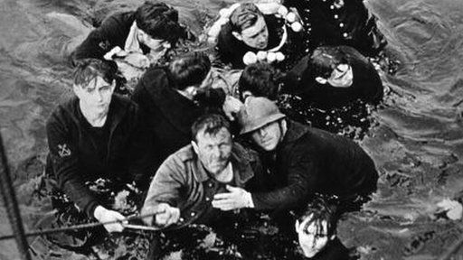 Crew members of the French destroyer Bourrasque, sunk by mine at Dunkirk, are hauled aboard a British vessel from their sinking life-raft.