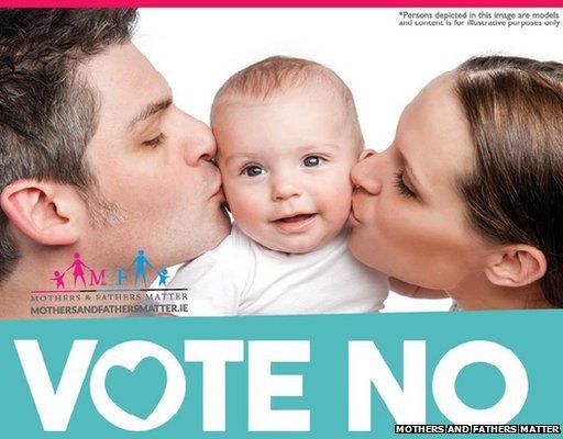 "no" poster featuring parents kissing baby