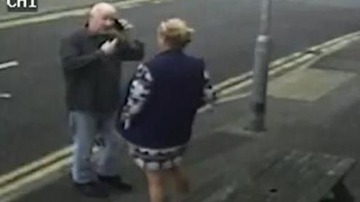 Stephanie Langley and Matthew Bryant on a pavement facing each other, he is on the phone