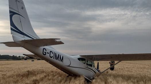 A light aircraft in the middle of a field