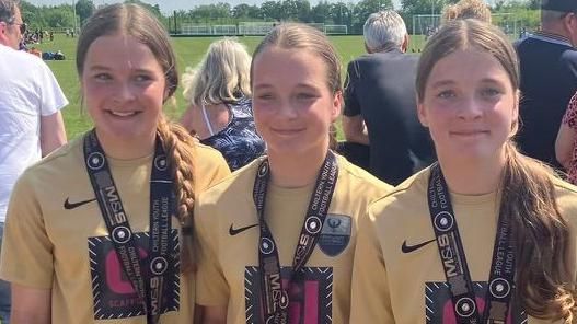 Lily Chloe and Ella, triples wearing a football medal