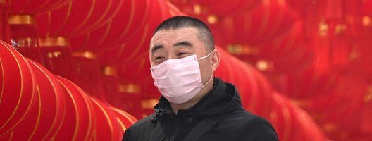 A man in China wearing a mask