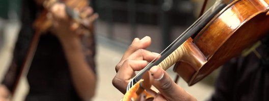 Closeup of a black violinist's hand playing