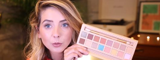 Screenshot of beauty vlogger Zoella holding an eyeshadow palette