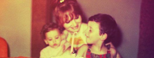 A vintage looking image recreation of a mother and her children on the daughter's first birthday