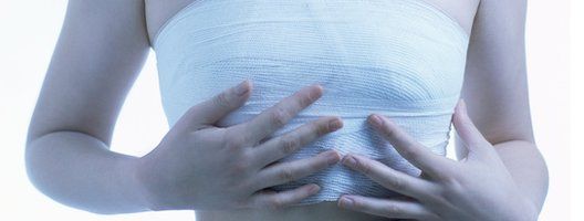 Stock image of woman in bandages after breast surgery
