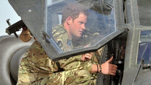 Prince Harry with an Apache helicopter