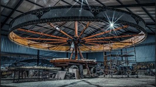 The carousel's bare wooden structure before it was restored