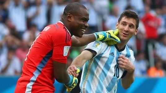 Goalkeeper Vincent Enyeama of Nigeria (left) shares a joke with Lionel Messi