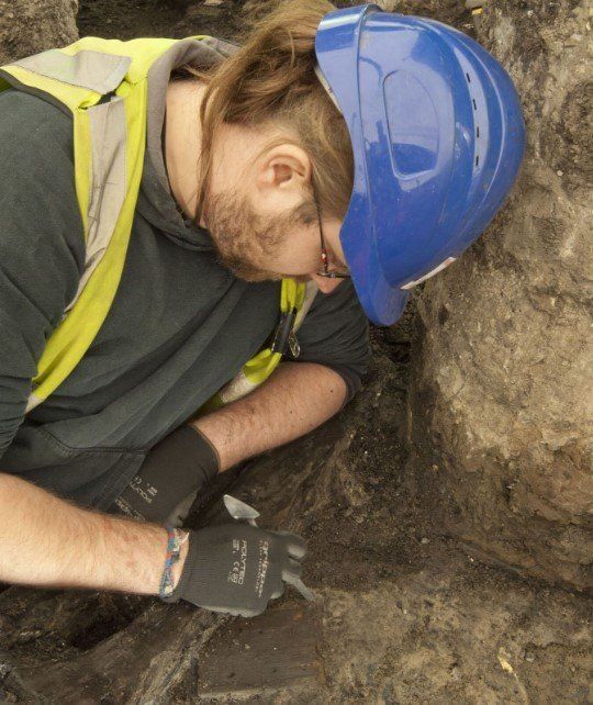 Archaeologist excavating writing tablet at Bloomberg
