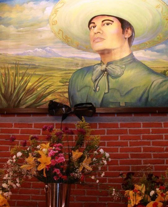 A makeshift memorial sits beneath a picture of Mexican singer Juan Gabriel in the Plaza Garibaldi, the iconic Plaza de los Mariachis in Mexico City, Mexico, 28 August 2016.