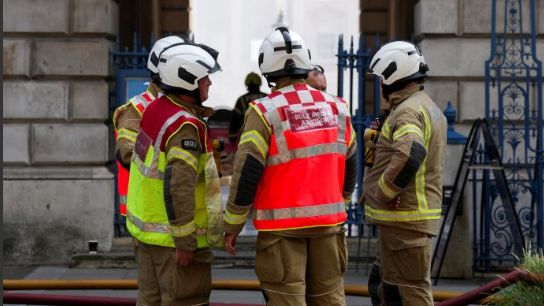 Firefighters work at the scene of a fire at Somerset House