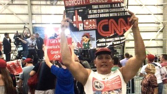 Twitter photo of Mr Sayoc holding an anti-CNN poster
