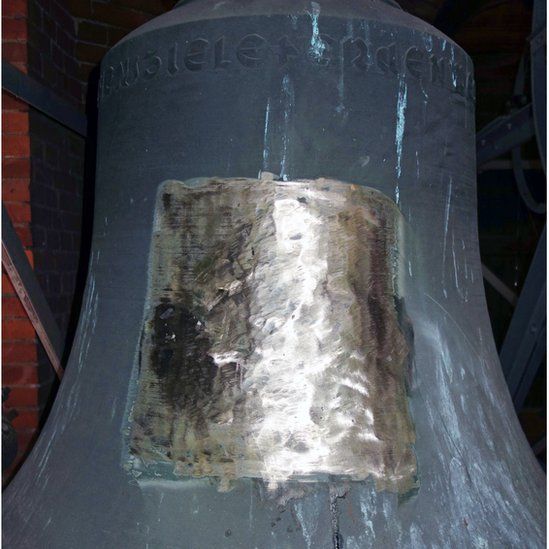 Bell showing huge chunk of damage to a bell