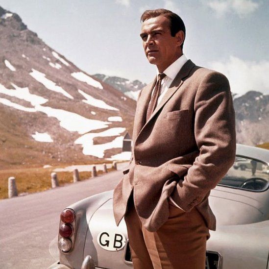 Goldfinger still - Bond with Aston Martin