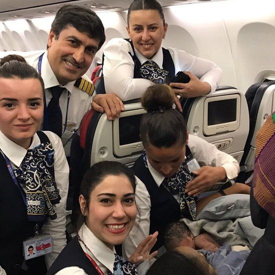 Turkish Airlines stewards with baby Kadiju