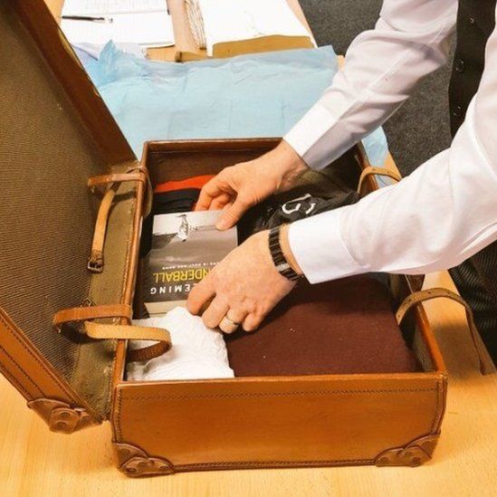 Butler packing suitcase