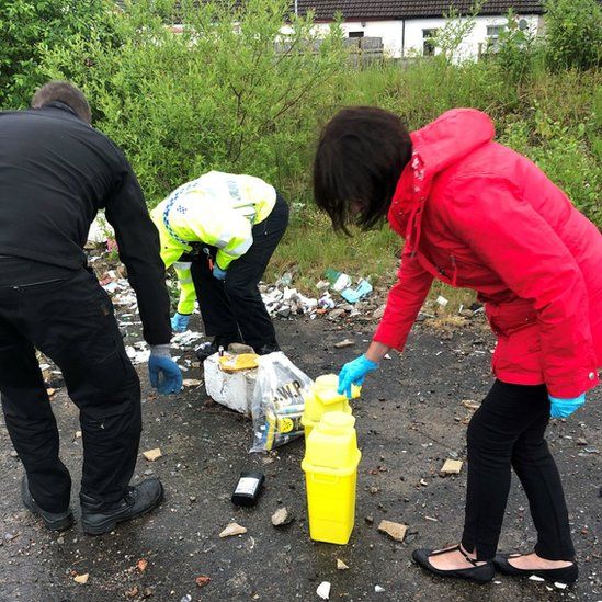 Council workers help to clean up the area