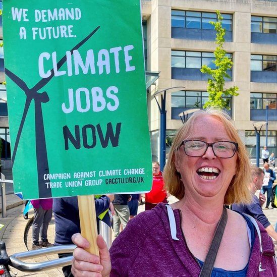 Salena Williams holding a Climate jobs now banner