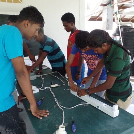 Teenagers take part in an electrical installation class at the Sunrise Center