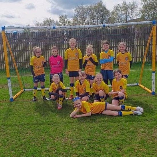 Girls' football team in yellow