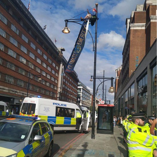 Protester climbs lamp post